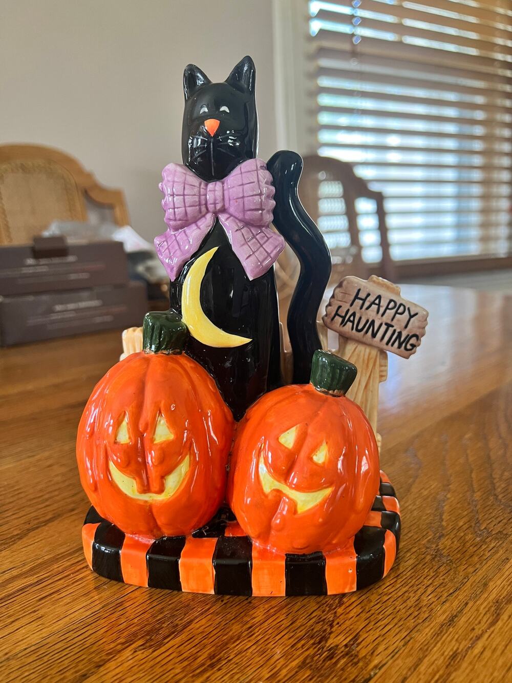 Black ceramic cat with pumpkins for Halloween table decoration.